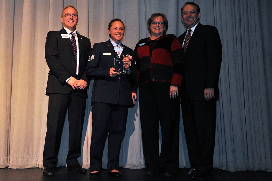 Staff Sgt. Krystle DeBiase from the 92nd Medical Operations Squadron, received the Military Heroes Award at the 10th Annual American Red Cross Honoring Hometown Heroes Luncheon Nov. 13, 2013, in Airway Heights, Wash. More than 600 Spokane community and service members were in attendance as these heroes were honored for their significant accomplishments and positive impacts on the lives of others. Senior Airman Kelly Gorham, 92nd MDOS, also recieved the award but was absent during the ceremony. (U.S. Air Force photo by Staff Sgt. Veronica Montes)