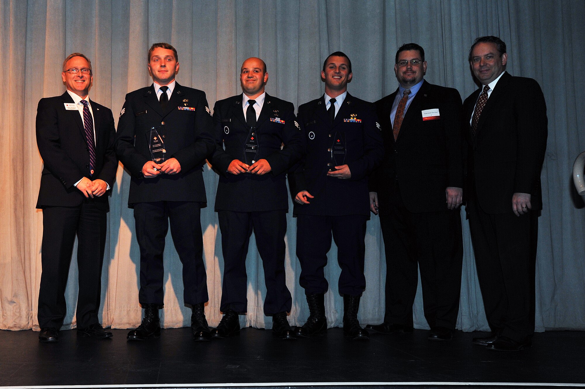 Senior Airman Cory Dilport, Senior Airman Anthony Fischer and Senior Airman Caleb Williams, 336th Training Group Survival, Evasion, Resistance and Escape specialists, received the Fire Safety Heroes Award at the 10th Annual American Red Cross Honoring Hometown Heroes Luncheon Nov. 13, 2013, in Airway Heights, Wash. More than 600 Spokane community and service members were in attendance as these heroes were honored for their significant accomplishments and positive impacts on the lives of others. (U.S. Air Force photo by Staff Sgt. Veronica Montes)