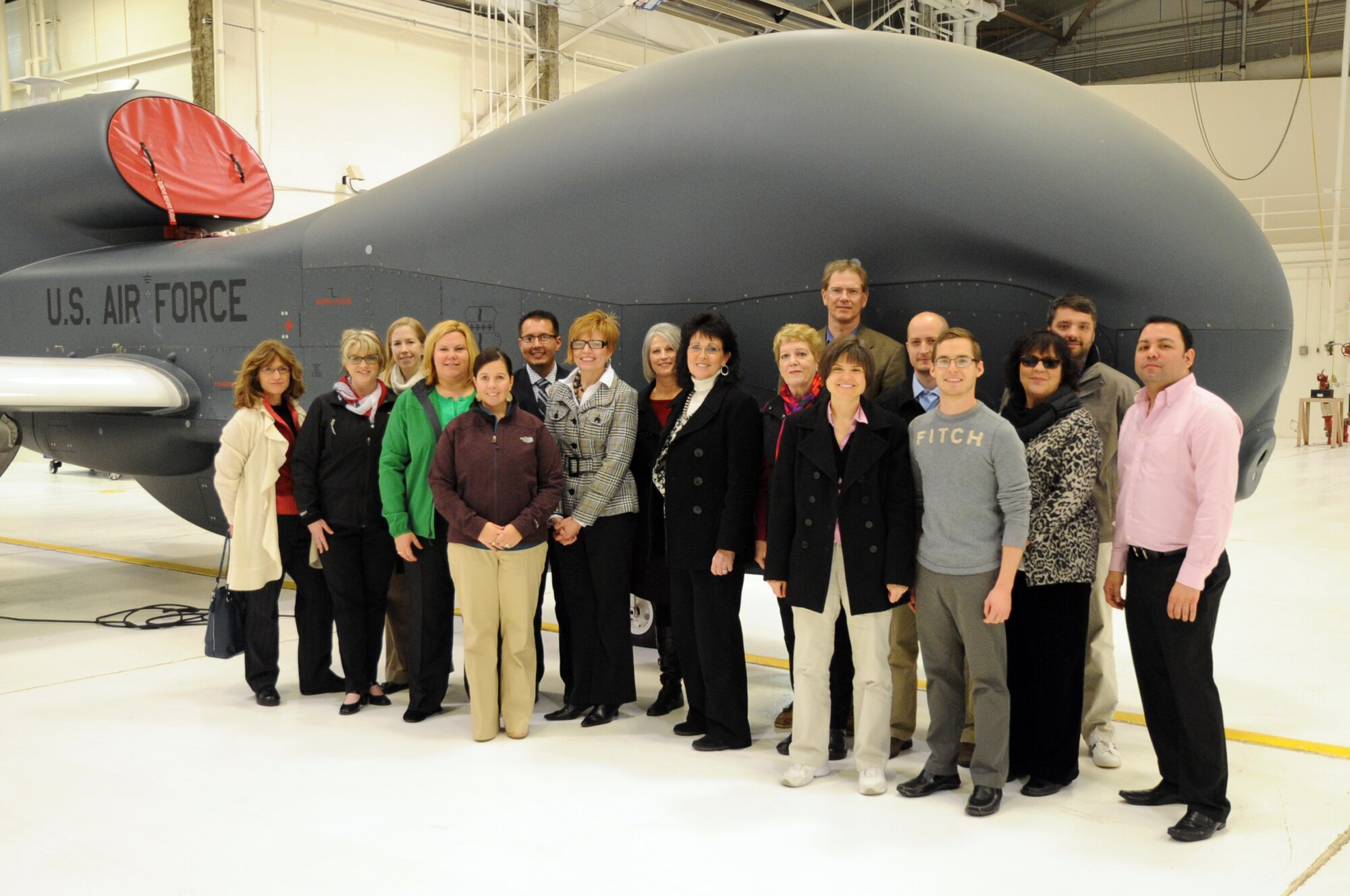 Members of North Dakota Senator Heidi Heitkamp's staff stand with a Block 40 Global Hawk aircraft during a visit to Grand Forks Air Force Base, N.D., Nov. 16, 2013. The congressional staff members visited the base to learn about its mission and conduct a training session. (U.S. Air Force photo/Staff Sgt. David Dobrydney)