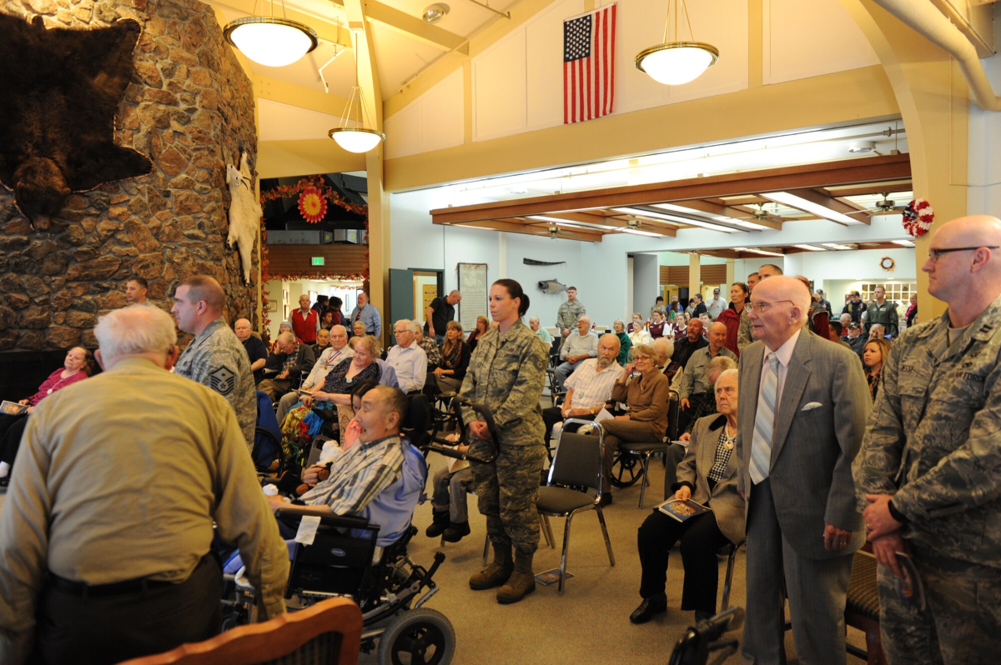 Veterans retired and active-duty stand during a Veterans Day ceremony at the Alaska Veterans and Pioneers' Home, Nov. 11, 2013. Members of the Joint Base Elmendorf-Richardson 3rd Operations Support Squadron drove an hour way to visit veterans on Veterans Day.  (U.S. Air Force Photo/Airman 1st Class Omari Bernard)
