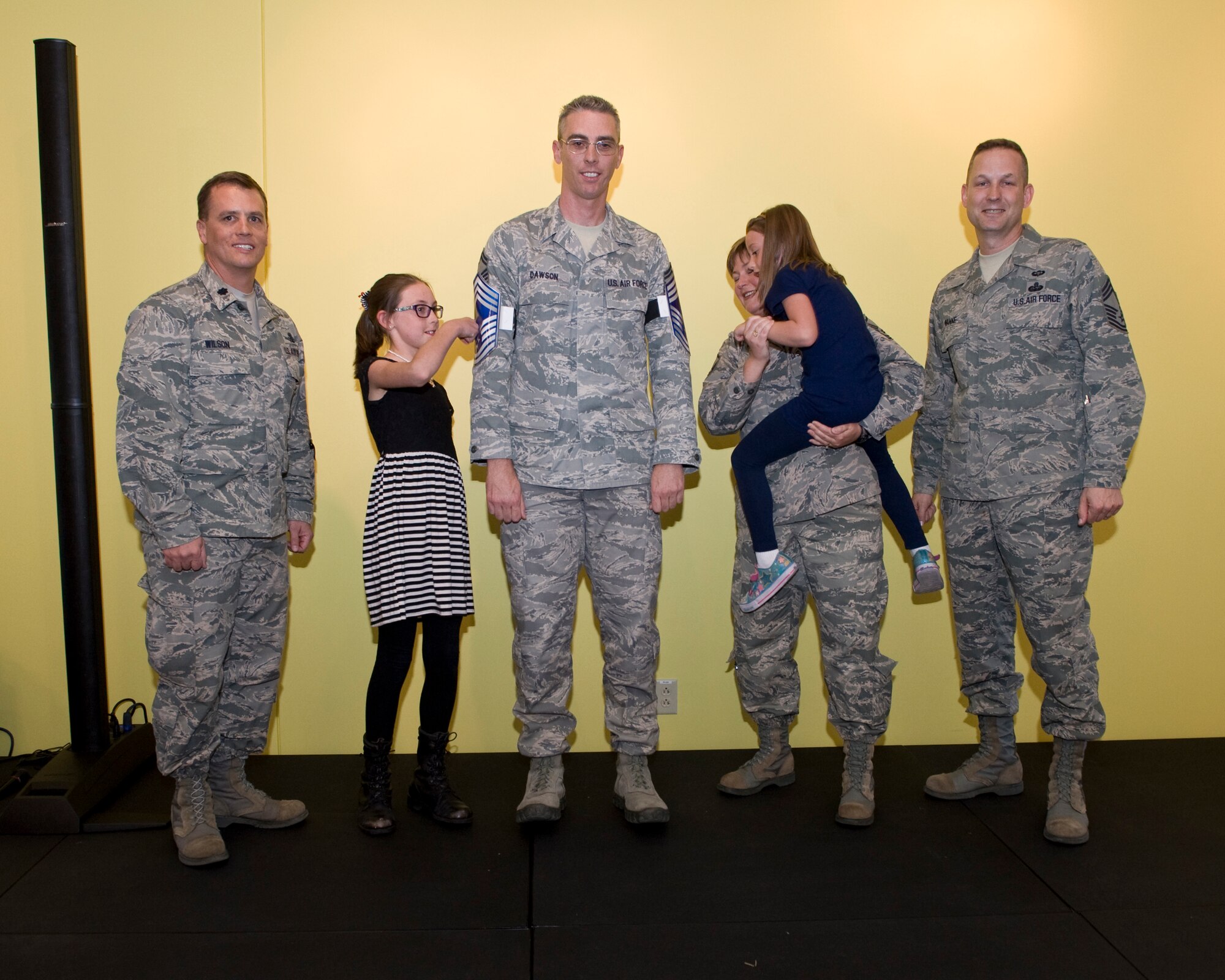 Senior Master Sgt. Jeff Dawson, Aerospace Data Facility-Colorado detachment chief, celebrates his selection to chief master sergeant with fellow squadron members and his family during the chief master sergeant release party Nov. 15, 2013, at the community center on Buckley Air Force Base, Colo. Members of Team Buckley celebrated the announcements of three new chief master sergeants selects. (U.S. Air Force photo by Senior Airman Phillip Houk/Released)