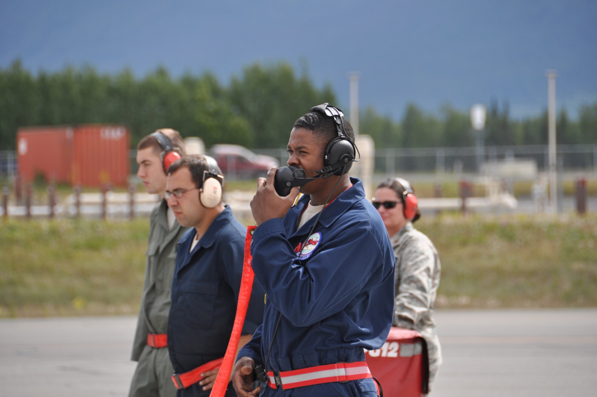 Airman 1st Class Jermaine James, an F-22 crew chief and Reservist assigned to the 477th AMXS, communicates with the pilot during the aircraft recovery during the 3rd Wings Turkey Shoot July 17. Pilots and aircraft maintainers were evaluated on their ability to produce and fly combat ready aircraft. (U.S. Air Force Photo/Tech. Sgt. Dana Rosso)
