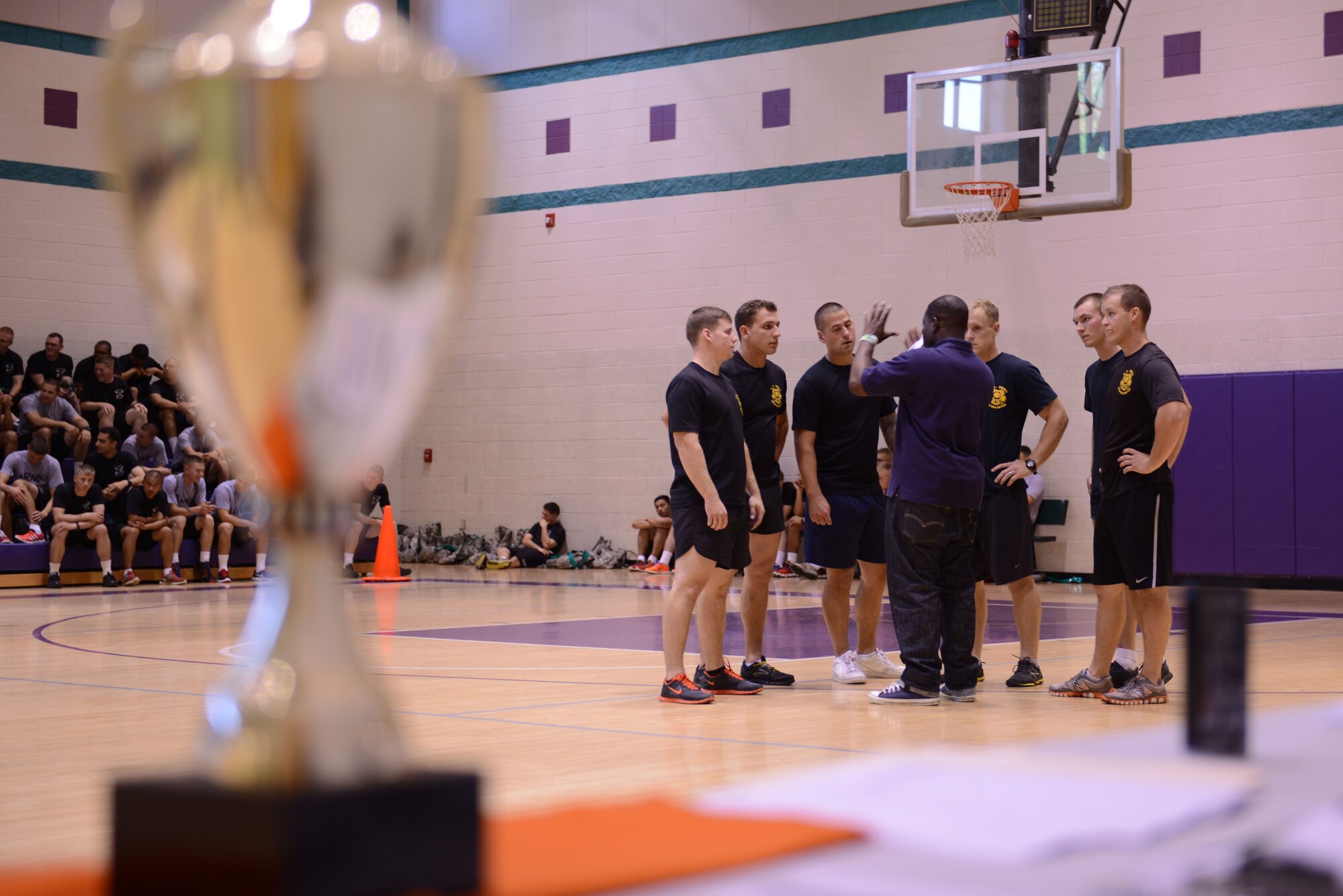 U.S. Army Soldiers huddle together before a dodgeball match at the McClellan Fitness Center at Fort Eustis, Va., Sept. 24, 2013. The Better Opportunities for Single Soldiers organization boasts a three-pillar mission: quality of life, community service and recreation and leisure. (U.S. Air Force photo by Staff Sgt. Ciara Wymbs/Released)