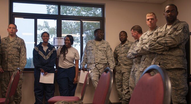 U.S. Air Force Airmen stand in front of the agree sign during an activity for Comprehensive Airmen Fitness Day at Moody Air Force Base, Ga., Nov. 15, 2013. The Airmen were given a scenario and had to choose if they agreed, disagreed or were neutral and then explained why they felt that way. (U.S. Air Force photo by Airman 1st Class Alexis Grotz/Released)