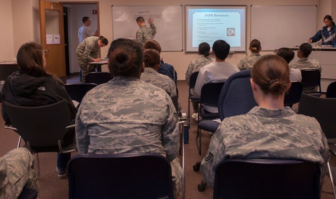 U.S. Air Force Airmen wait for a Sexual Assault Response Coordinator briefing during a Comprehensive Airman Fitness (CAF) Day at Moody Air Force Base, Ga., Nov. 15, 2013. The briefing helped to remind Airmen of the many different resources available to them. (U.S. Air Force photo by Airman 1st Class Alexis Grotz/Released)