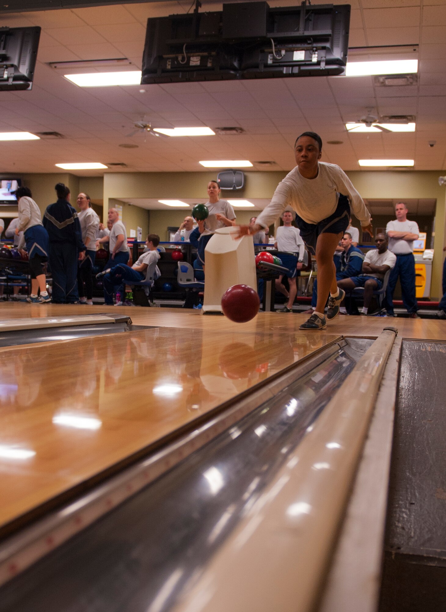 U.S. Air Force Staff Sgt. Shahayla Colson, 347th Operation Support Squadron aircrew flight equipment technician, throws a bowling ball during a Comprehensive Airman Fitness (CAF) Day event at Moody Air Force Base, Ga., Nov. 15, 2013. Combat bowling fell under the physical pillar of the four-pillar CAF program. (U.S. Air Force photo by Airman 1st Class Alexis Grotz/Released)