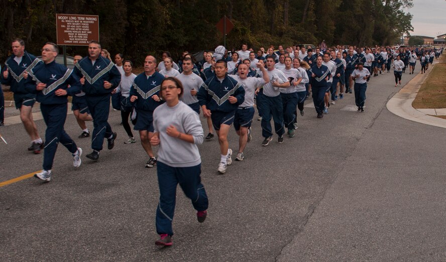 U.S. Air Force Airmen run in formation for a base-wide run during a Comprehensive Airman Fitness Day at Moody Air Force Base, Ga., Nov. 15, 2013. The 2.3 mile run, which started and ended at the President George W. Bush Air Park, kicked off CAF Day and focused on the physical pillar. (U.S. Air Force photo by Airman 1st Class Alexis Grotz/Released)