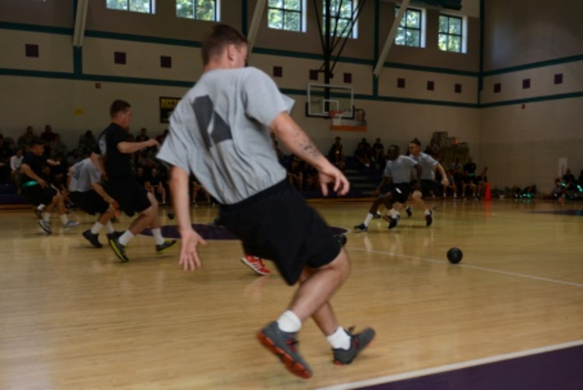 U.S. Army Soldiers race to grab dodgeballs during a dodgeball tournament held at the McClellan Fitness Center at Fort Eustis, Va., Sept. 24, 2013. The tournament was hosted by Better Opportunities for Single Soldiers, or BOSS, a program that supports the overall quality of life for single and unaccompanied Service members. (U.S. Air Force photo by Staff Sgt.Ciara Wymbs/Released)