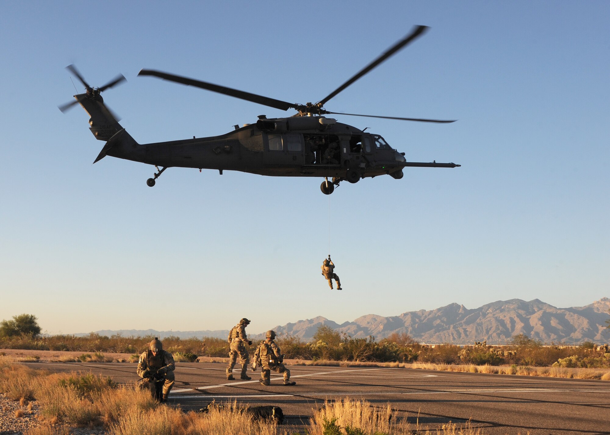 A U.S. Air Force pararescueman from the 48th Rescue Squadron at Davis-Monthan AFB, Ariz. is hoisted from a 55th Rescue Squadron HH-60 Pavehawk during alternate insertion and extraction training here, Nov. 13, 2013. The pararescuemen were participating in the exercise as part of their upgrade training.  (U.S. Air Force photo by 1st Lt Sarah Ruckriegle/released) 