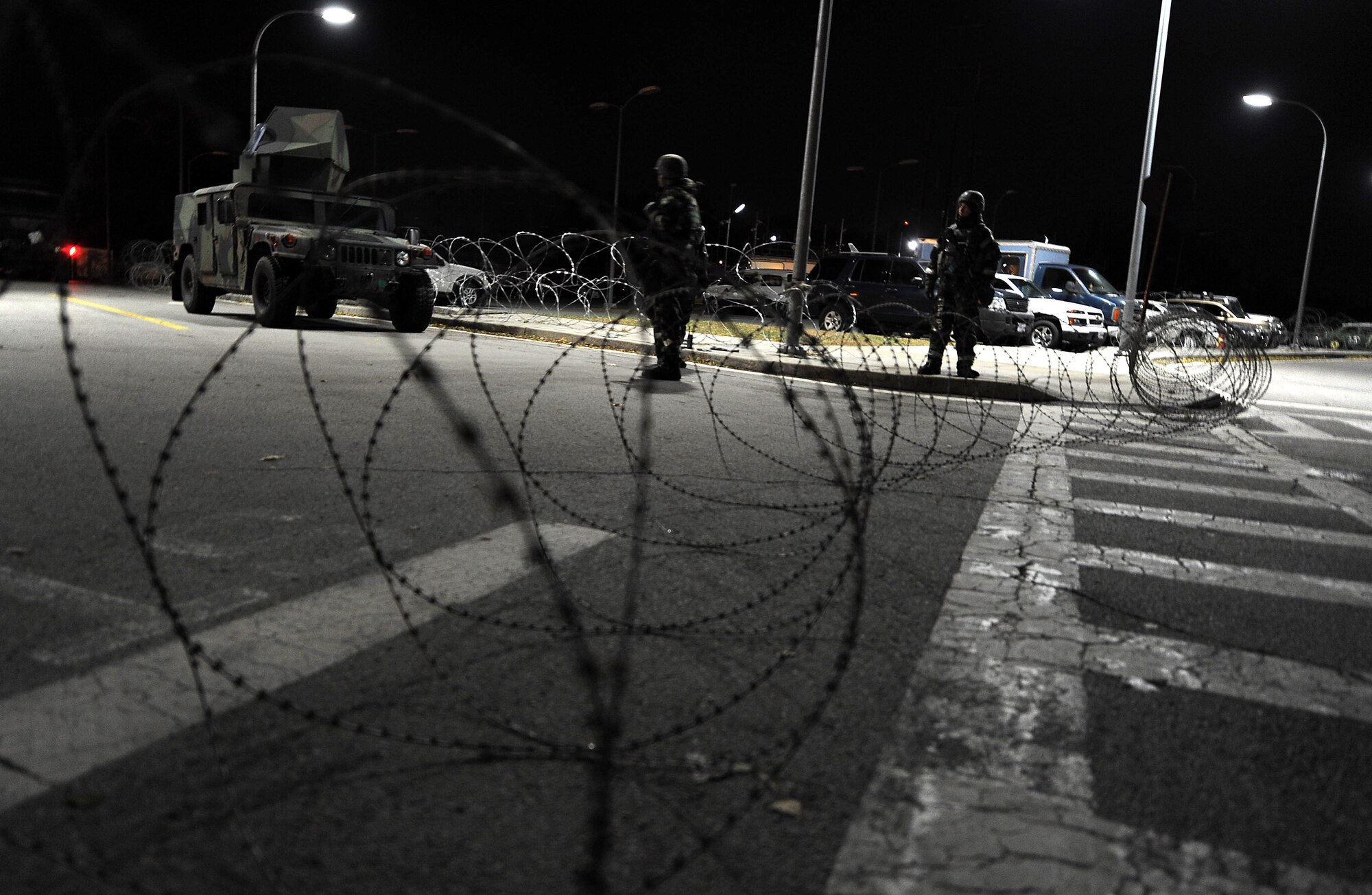 Members of the 51st Security Forces Squadron guard the entrance to Bldg. 1097 during Operational Readiness Beverly Bulldog 14-01 at Osan Air Base, Republic of Korea, Nov. 19, 2013. Airmen will continue to control the area surrounding the building throughout the ORE as part of their defensive posture. (U.S. Air Force photo/Staff Sgt. Sara Csurilla)