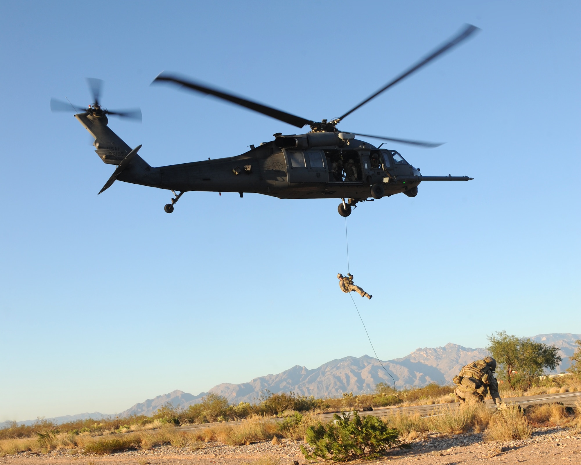 A U.S. Air Force pararescueman from the 48th Rescue Squadron at Davis-Monthan Air Force Base, Ariz., rappels from a 55th Rescue Squadron HH-60 Pavehawk during alternate insertion and extraction training  here, Nov. 13, 2013. The pararescuemen were participating in the exercise as part of their upgrade training. (U.S. Air Force photo by 1st Lt Sarah Ruckriegle/released) 