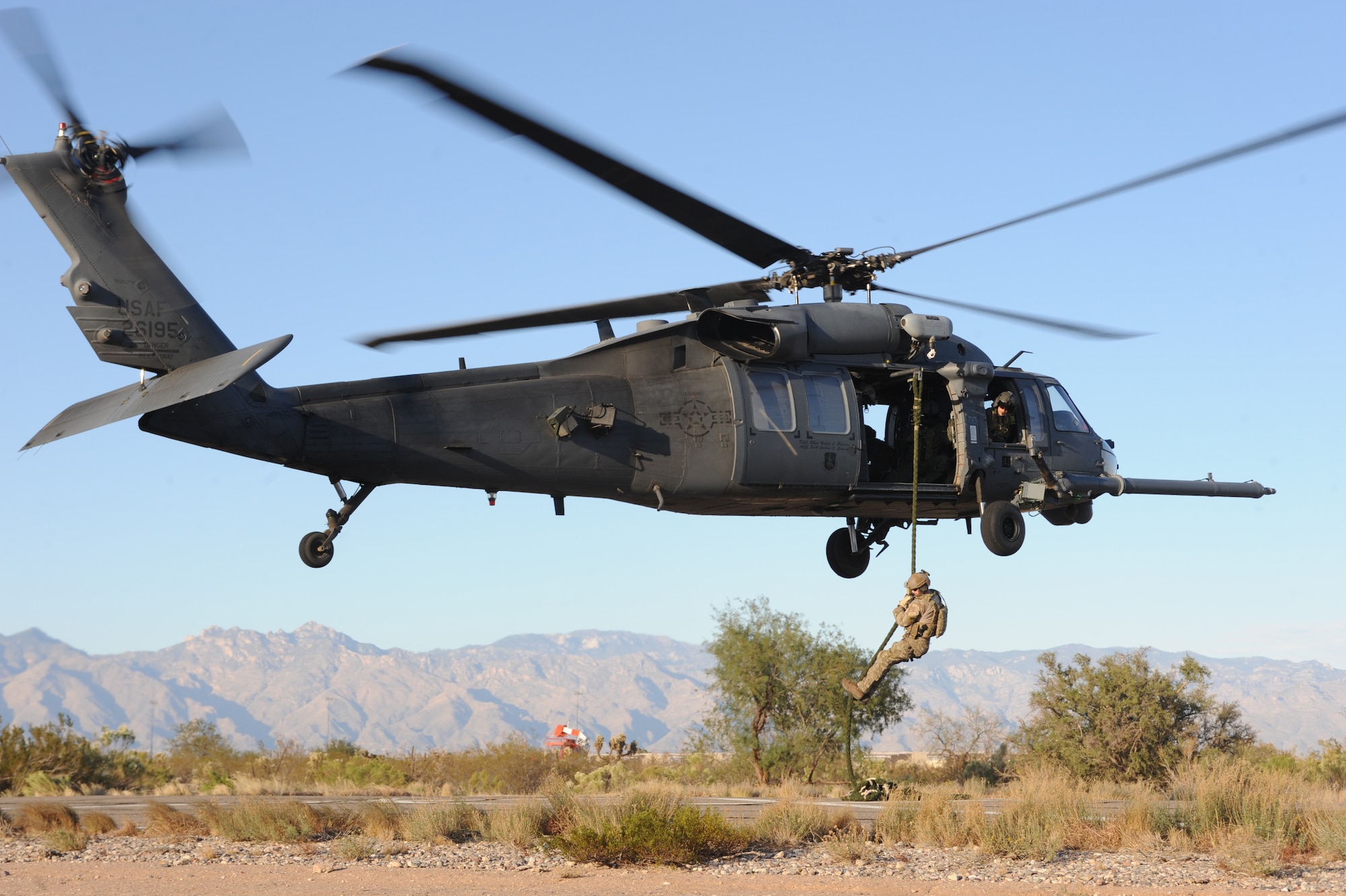 A U.S. Air Force combat rescue officer from the 48th Rescue Squadron at Davis-Monthan Air Force Base, Ariz. descends on a fast rope during alternate insertion and extraction training here, Nov. 13, 2013. (U.S. Air Force photo by 1st Lt Sarah Ruckriegle/released) 