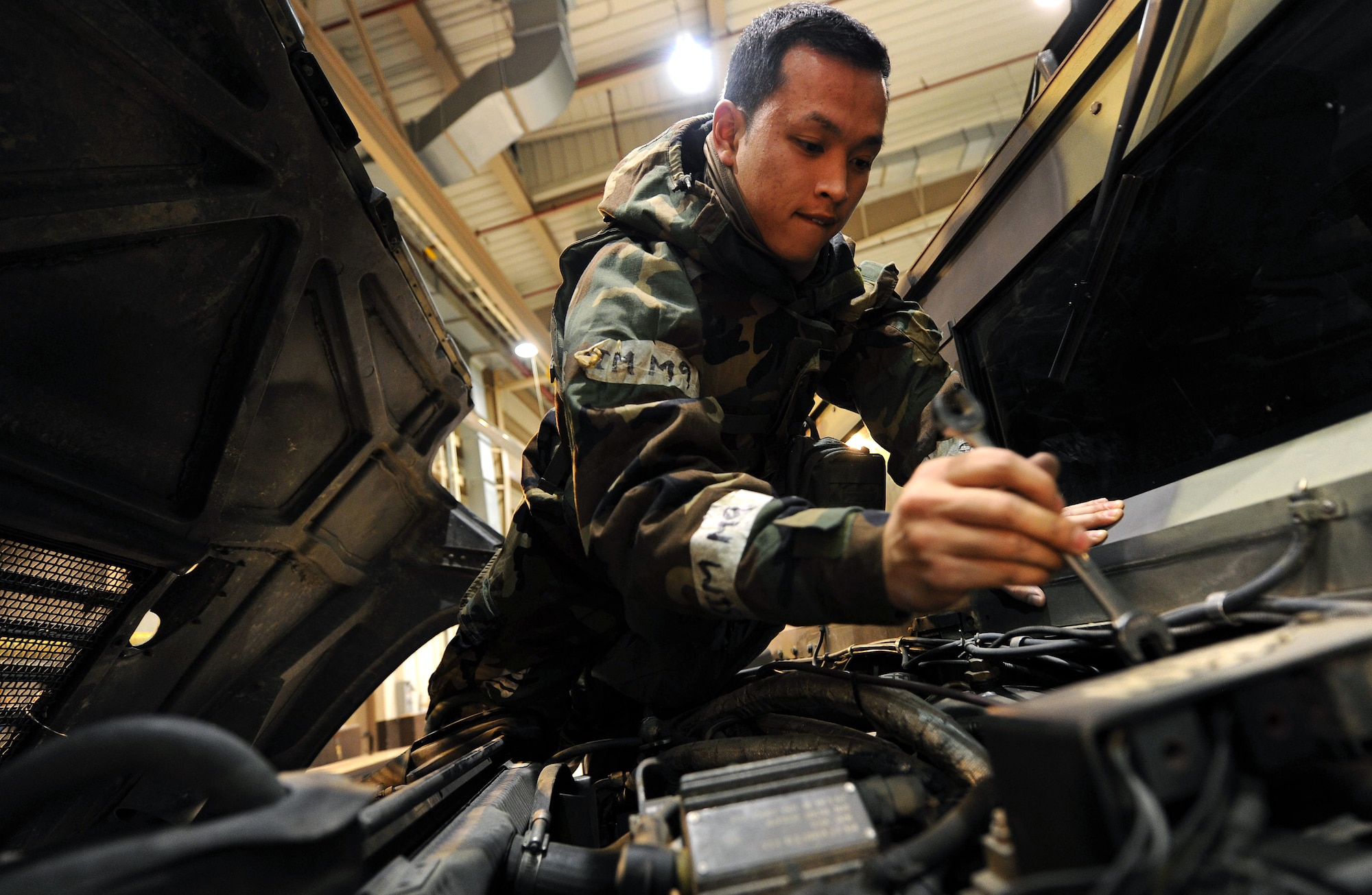 Senior Airman Daniel Dydasco, 51st Logistics Readiness Squadron vehicle maintenance technician, services a Humvee during Operational Readiness Exercise Beverly Bulldog 14-01 at Osan Air Base, Republic of Korea, Nov. 19, 2013. OREs like BB 14-01 test Airmen’s ability to accomplish their mission under the stressors associated with wartime conditions. (U.S. Air Force photo/Staff Sgt. Sara Csurilla)
