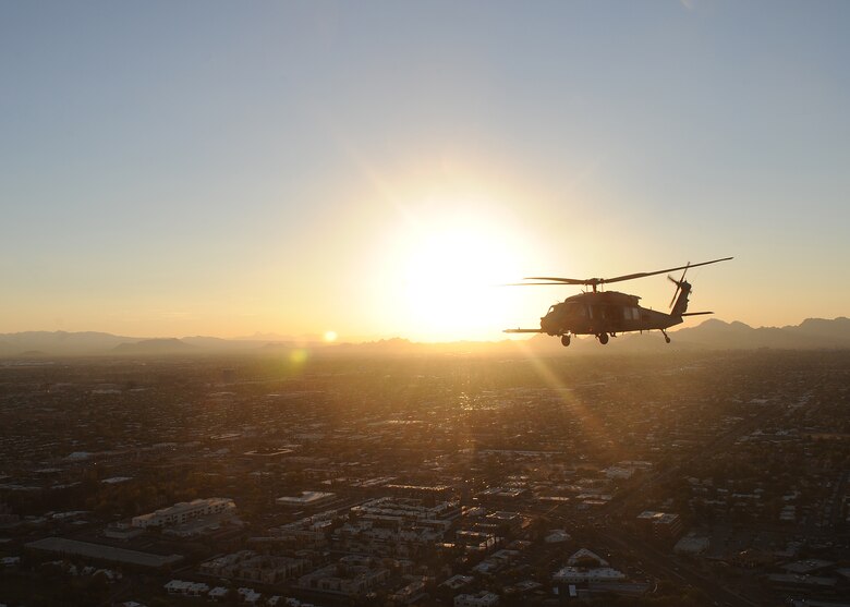 An HH-60 Pavehawk from the 55th Rescue Squadron at Davis-Monthan Air Force Base, Ariz., flies over Tucson during alternate insertion and extraction training with the pararescuemen of the 48th Rescue Squadron, Nov. 13, 2013.  (U.S. Air Force photo by 1st Lt Sarah Ruckriegle/released) 