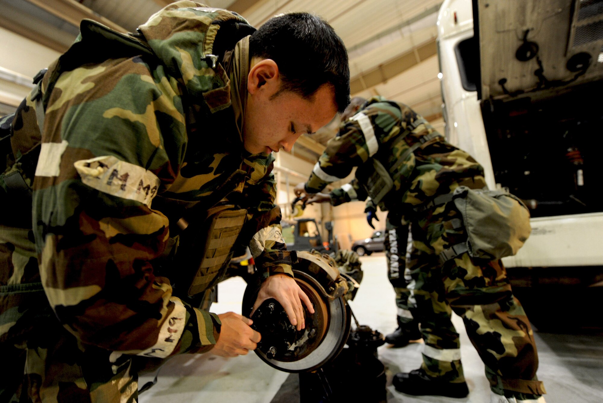 Senior Airman Daniel Dydasco, 51st Logistics Readiness Squadron vehicle maintenance technician, tends to the axle of a large truck during Operational Readiness Exercise Beverly Bulldog 14-01 at Osan Air Base, Republic of Korea, Nov. 19, 2013. VM mechanics perform all levels of maintenance from simple part changes to component rebuilds, as well as full-service body repairs. (U.S. Air Force photo/Staff Sgt. Sara Csurilla)