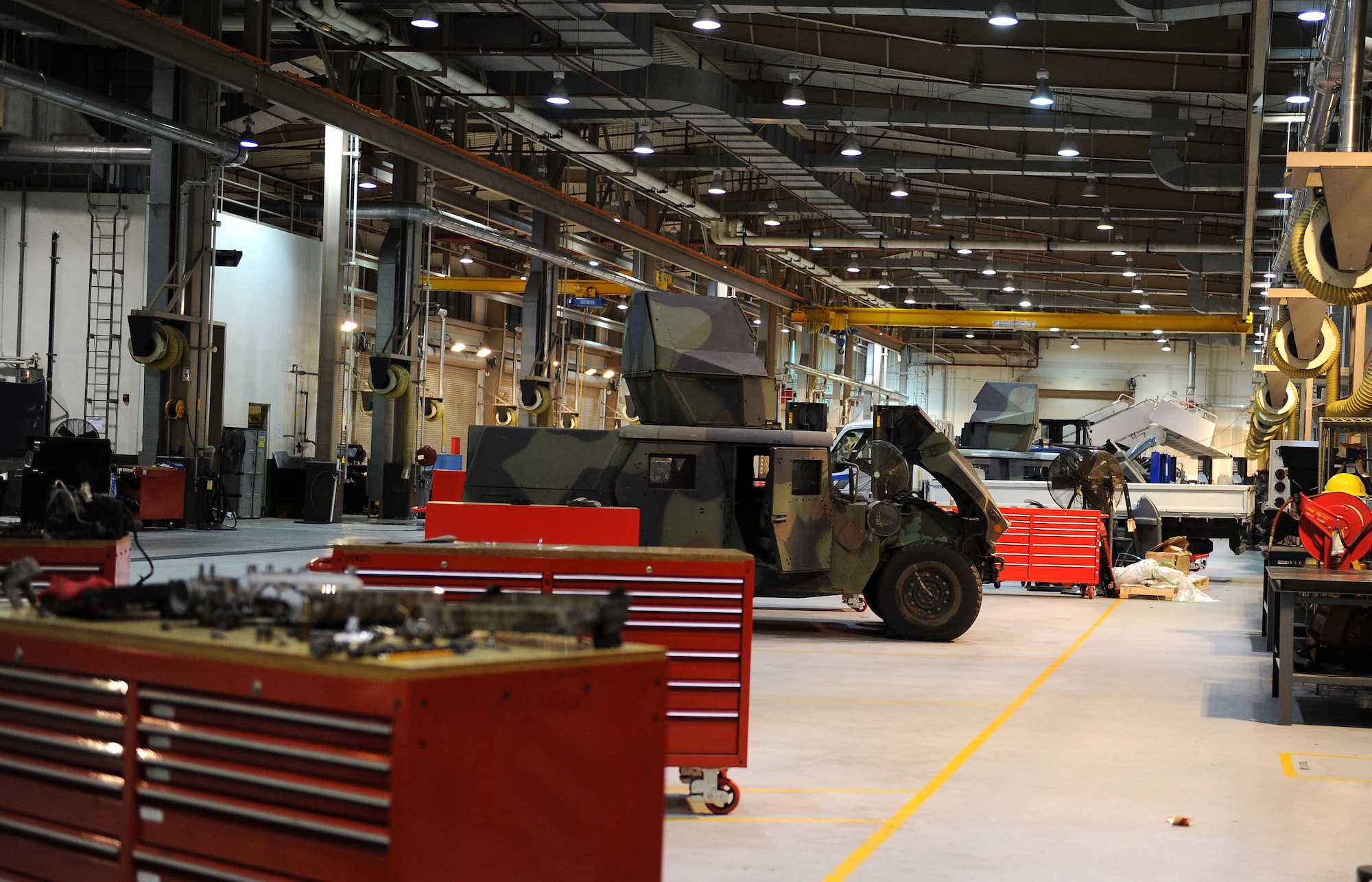 Tactical vehicles wait to be serviced inside the 51st Logistics Readiness Squadron vehicle maintenance flight’s repair bay during Operational Readiness Exercise Beverly Bulldog 14-01 at Osan Air Base, Republic of Korea, Nov. 19, 2013. VM techs are charged with keeping the 51st Fighter Wing’s entire vehicle fleet up and running. (U.S. Air Force photo/Staff Sgt. Sara Csurilla)