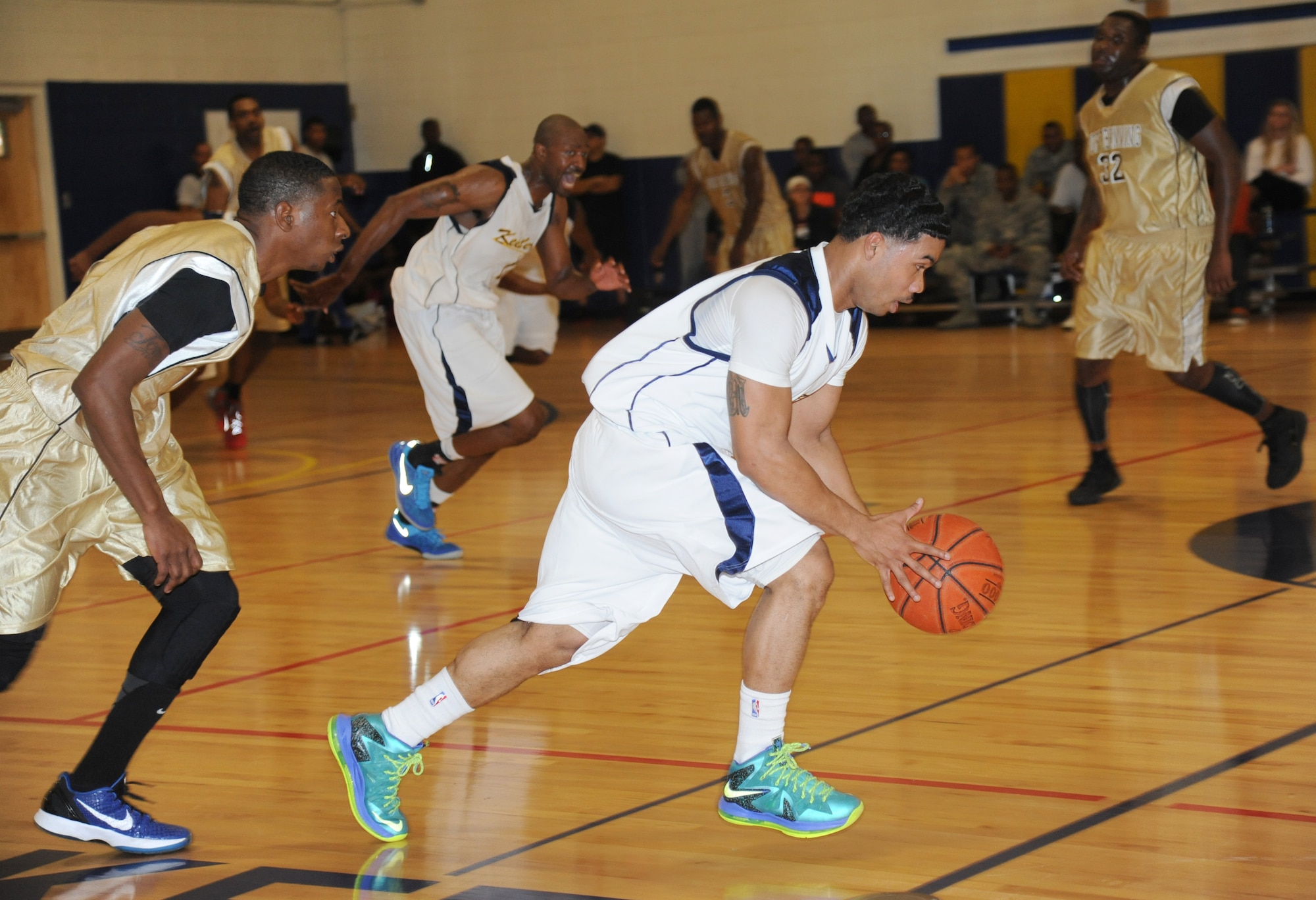 Anthony McMillan, Fort Benning, chases Mario McKnight, Keesler, as he drives the ball down court during a men’s varsity basketball game Nov. 16, 2013, Keesler Air Force Base, Miss.  Keesler defeated Fort Benning 70-68.  (U.S. Air Force photo by Kemberly Groue)