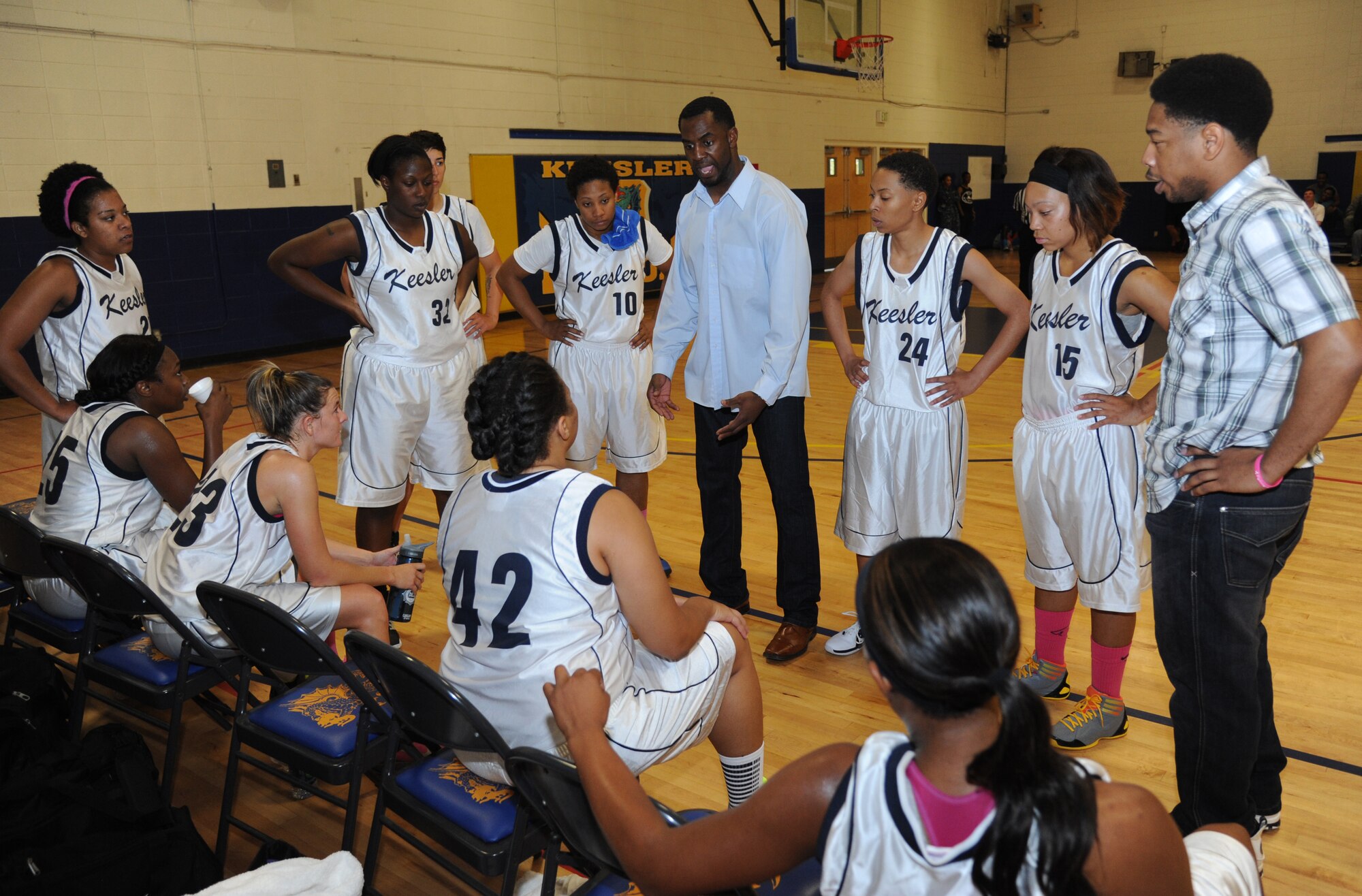 Jason Washington, Keesler head coach, takes advantage of a time-out by speaking to his players during a women’s varsity basketball game Nov. 16, 2013, Keesler Air Force Base, Miss.  Maxwell-Gunter defeated Keesler 70-60.  (U.S. Air Force photo by Kemberly Groue)