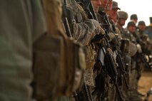 Members of the 91st Security Forces Group convoy and tactical response force stand in formation during a debrief after a recapture, recovery exercise Nov. 14, 2013. The exercise is used as a training tool to evaluate the responding forces, their reaction of denying access to the resource from hostile actions, and recovery of the resource if access is gained. (U.S. Air Force photo/Senior Airman Brittany Y. Auld)