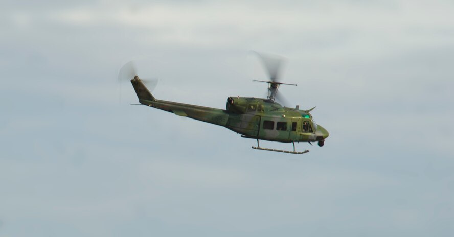 A UH-1N Huey from the 54th Helicopter Squadron flies over the exercise site during 91st Security Forces Group recapture, recovery training Nov. 14, 2013. The exercise is used as a training tool to evaluate the responding forces, their reaction of denying access to the resource from hostile actions, and recovery of the resource if access is gained. (U.S. Air Force photo/Senior Airman Brittany Y. Auld)
