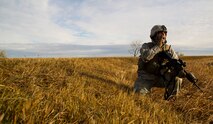 Staff Sgt. Joseph Misciagna, 791st Missile Security Forces Squadron convoy response force member relays messages to his team during a recapture, recovery exercise, Nov. 14, 2013. The exercise is used as a training tool to evaluate the responding forces, their reaction of denying access to the resource from hostile actions, and recovery of the resource if access is gained.  (U.S. Air Force photo/Senior Airman Brittany Y. Auld)