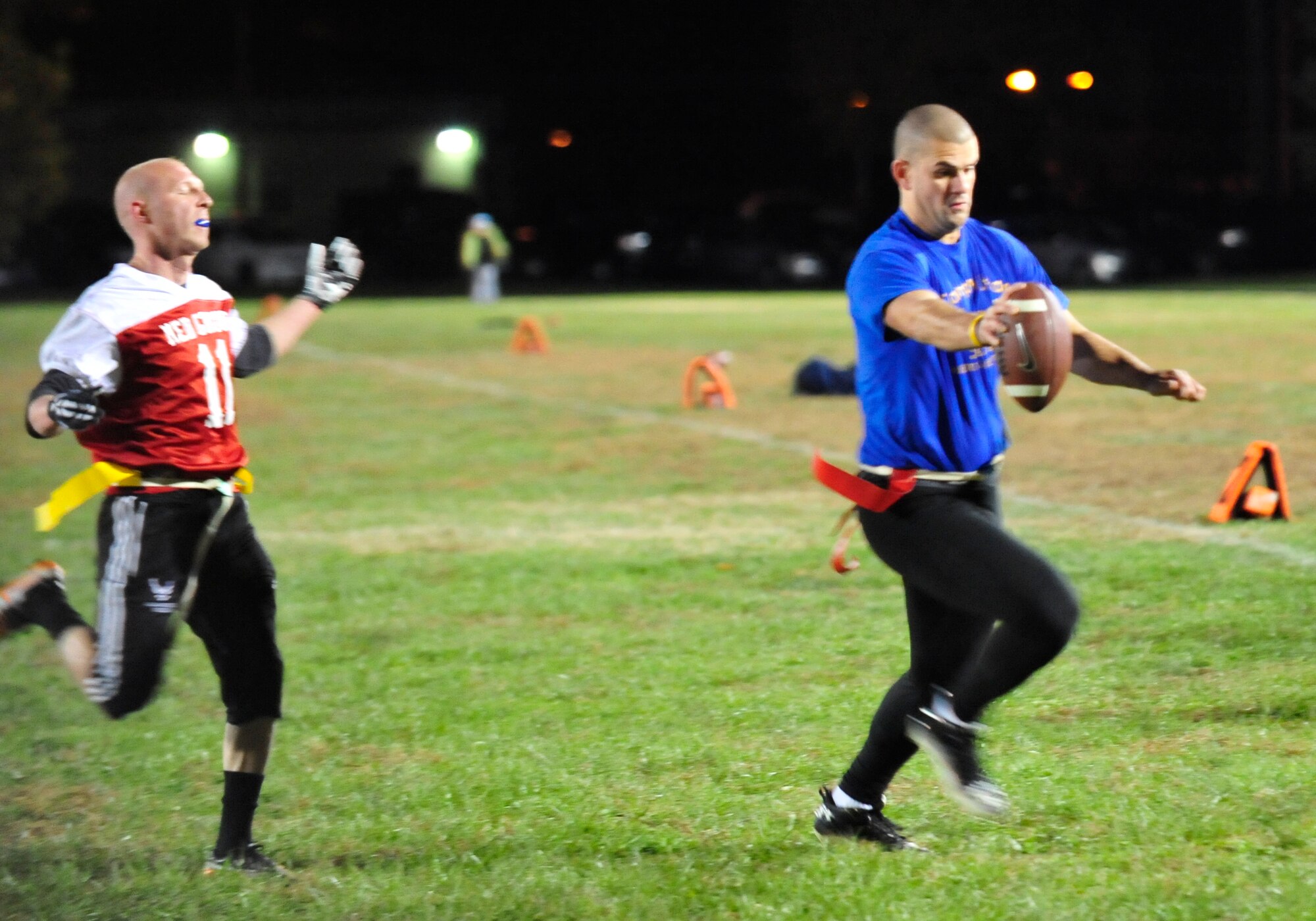 Cid Fernandez, 9th Airlift Squadron quarterback, rushes for a touchdown as a 436th Medical Group defender attempts to catch up during a flag football game Nov. 14, 2013, at Dover Air Force Base, Del. The 9th AS defeated the 436th MDG 32-12, and remains undefeated on the season. (U.S. Air Force photo/Airman 1st Class William Johnson)