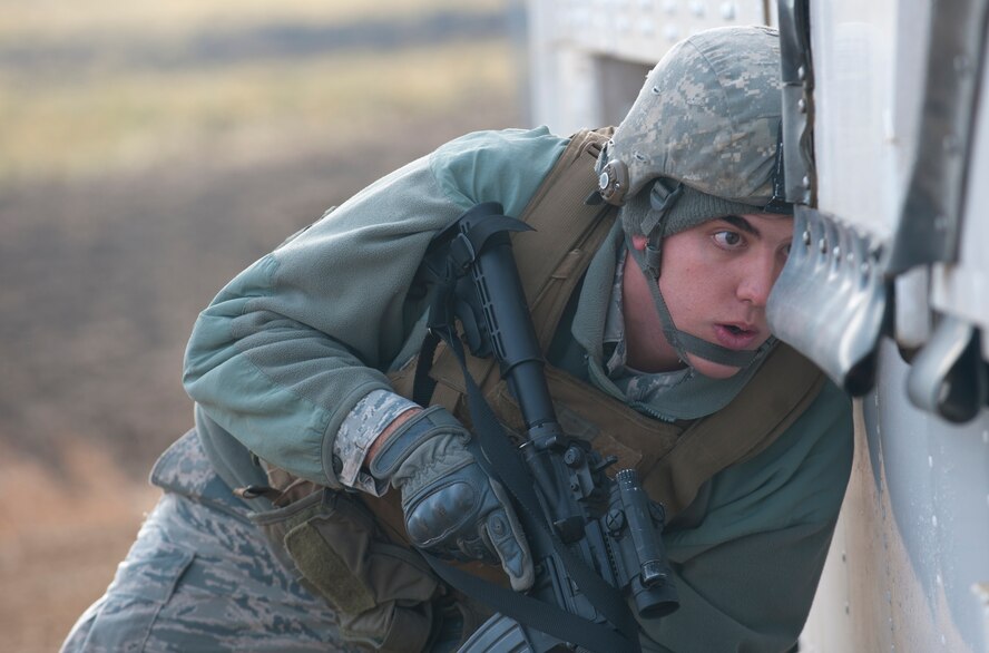 Airman 1st Class Paul Garcia, 791st Missile Security Forces Squadron convoy response force member, searches a payload transporter vehicle for foreign objects during a recapture, recovery exercise, Nov. 14, 2013. The exercise allowed 91st SFG Airmen to practice the necessary procedures that must be made when an asset is compromised. (U.S. Air Force photo/Airman 1st Class Apryl Hall)