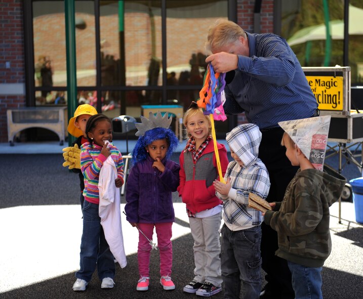 Greg Allen, The Magic of Recycling presenter, performs an interactive magic trick at the Child Development Center II, Moody Air Force Base, Ga., Nov. 14, 2013. Allen hopes his presentation can influence children to understand the value of recycling. (U.S. Air Force photo by Senior Airman Olivia Bumpers/Released)