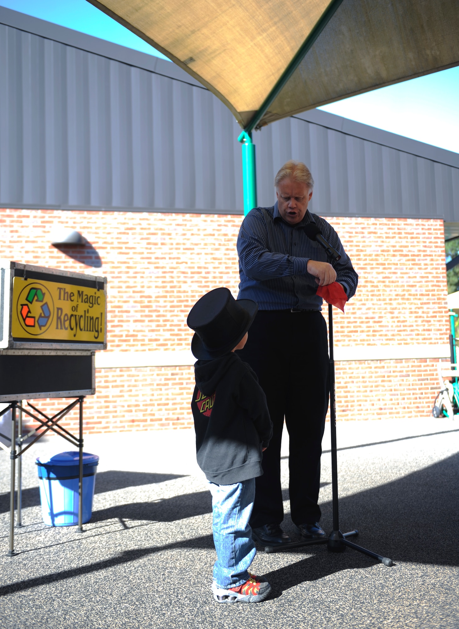 Greg Allen, The Magic of Recycling presenter, performs a magic trick at the Child Development Center II, Moody Air Force Base, Ga., Nov. 14, 2013. Allen visited the CDC for America Recycles Day to educate children on the importance of recycling. (U.S. Air Force photo by Senior Airman Olivia Bumpers/Released) 
