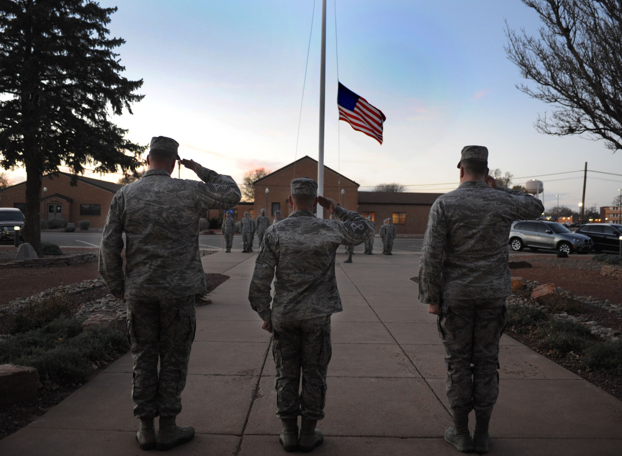 Chief Master Sgt. William Turner, Air Force Special Operations Command command chief, honors the flag during the weekly retreat ceremony Nov. 13, 2013, at Cannon Air Force Base, N.M. Turner visited in order to observe Cannon’s progress as a special operations base and interact with Cannon’s Air Commando’s. (U.S. Air Force photo/Senior Airman Ericka Engblom)