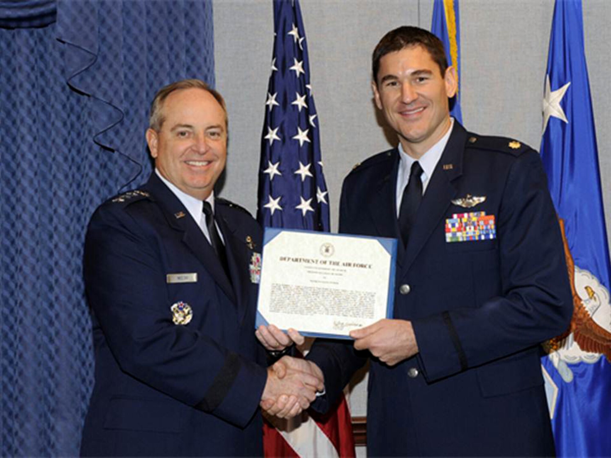 Maj. Douglas Witmer is honored by Air Force Chief of Staff Gen. Mark A. Welsh III during a ceremony Nov. 14, 2013, in the Pentagon. Witmer is this year's recipient of the Koren Kolligian Jr. trophy for outstanding Airmanship. Several members of the Kolligian family were present during the ceremony. (U.S. Air Force photo/Andy Morataya)
