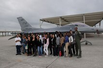 F-16 pilot 1st Lt. Chris Harrison and youth from the Little Havana and Homestead Career Centers pose for a group picture during a base tour of Homestead Air Reserve Base, Fla., on Nov. 15. Harrison is assigned to Detachment 93, 495th Fighter Group. (U.S. Air Force photo/Tim Norton)