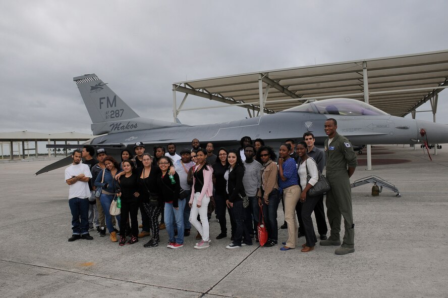 F-16 pilot 1st Lt. Chris Harrison and youth from the Little Havana and Homestead Career Centers pose for a group picture during a base tour of Homestead Air Reserve Base, Fla., on Nov. 15. Harrison is assigned to Detachment 93, 495th Fighter Group. (U.S. Air Force photo/Tim Norton)