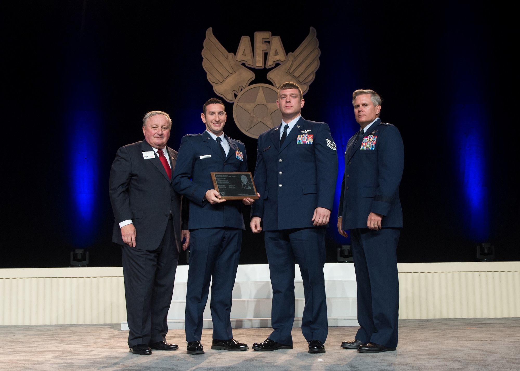 U.S. Air Force Capt. Matthew Taylor, second from left, 67th Special Operations Squadron MC-130P Combat Shadow pilot, and U.S. Air Force Tech. Sgt. Michael Schoettlin, second from right, 67th SOS MC-130P Combat Shadow loadmaster, receive the 2012 General William H. Tunner Award Sept. 16, 2013, during the Air Force Association's Air and Space Conference and Technology Exposition at the Gaylord National Convention Center in National Harbor, Md. The award recognizes the best airlift crew in the U.S. Air Force. (Photo Courtesy of the Air Force Association/Released)