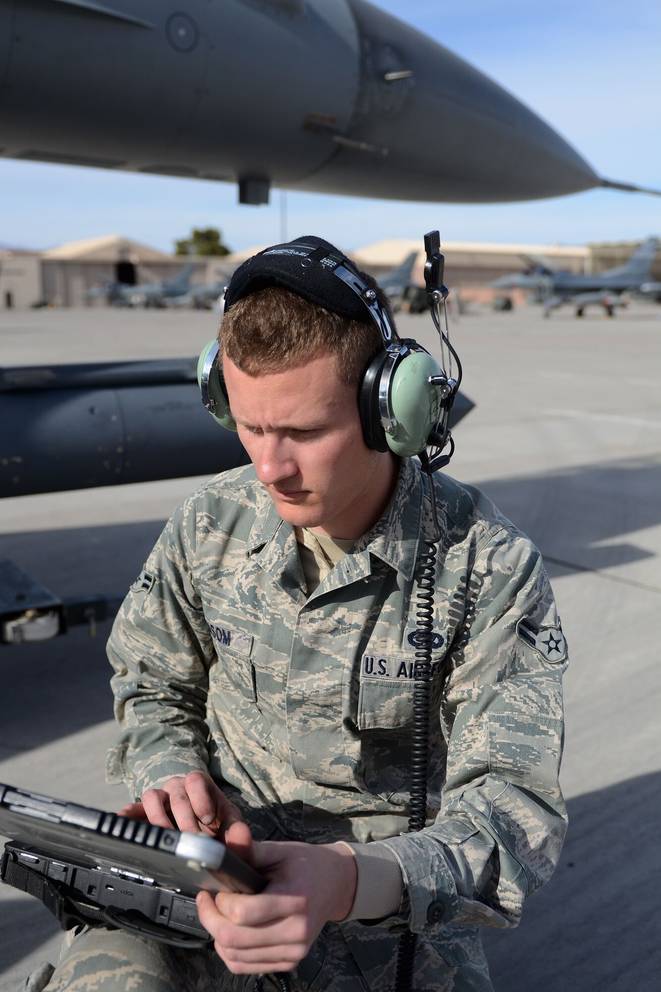 U.S. Air Force Airman 1st Class Christopher Ransom, an avionics technician with the 169th Aircraft Maintenance Squadron at McEntire Joint National Guard Base, South Carolina Air National Guard, reads the technical order to attach a sniper pod to an F-16 Fighting Falcon fighter jet at Nellis Air Force Base, Nev., on Nov. 7, 2013. Members of the 169th Fighter Wing are at Nellis to train for an upcoming Aerospace Expeditionary Force deployment and to support Green Flag-West, a joint close-air support training mission for forces preparing to support combat operations.
(U.S. Air National Guard photo by Tech. Sgt. Caycee Watson/Released)