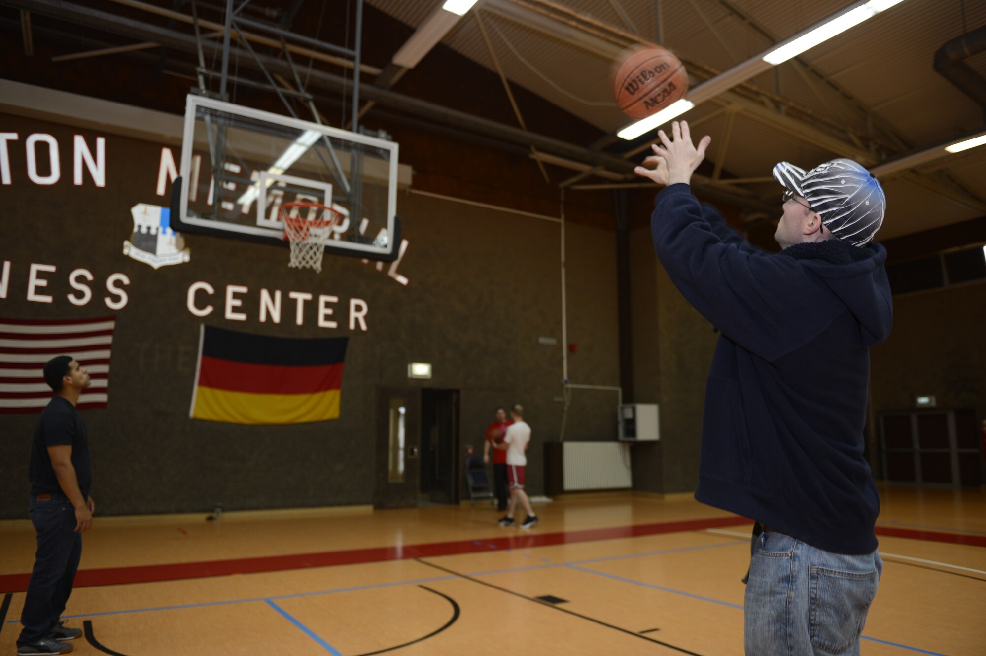 SPANGDAHLEM AIR BASE, Germany— U.S. Air Force Staff Sgt. Ben Knight, 52nd Logistic Readiness Squadron logistic planner, shoots a basket for points toward the Airman & Family Readiness Center scavenger hunt Nov. 16, 2013. Families had one hour to collect more than 23 items from around base including the library, Skelton Memorial Fitness Center, Saber Conference Center and the Red Cross on Spangdahlem. (U.S. Air Force photo by Staff Sgt. Christopher Ruano/Released)