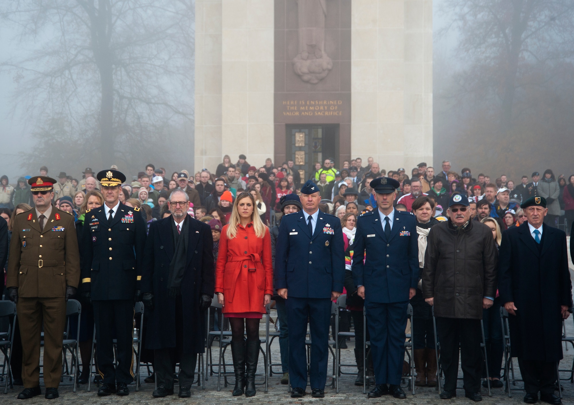 Attendees of a Veterans Day ceremony stand during the posting of the Colors, Nov. 11, 2013, Luxembourg American Cemetery and Memorial, Luxembourg. The ceremony was held in honor of veterans throughout the world. (U.S. Air Force photo/Senior Airman Damon Kasberg)