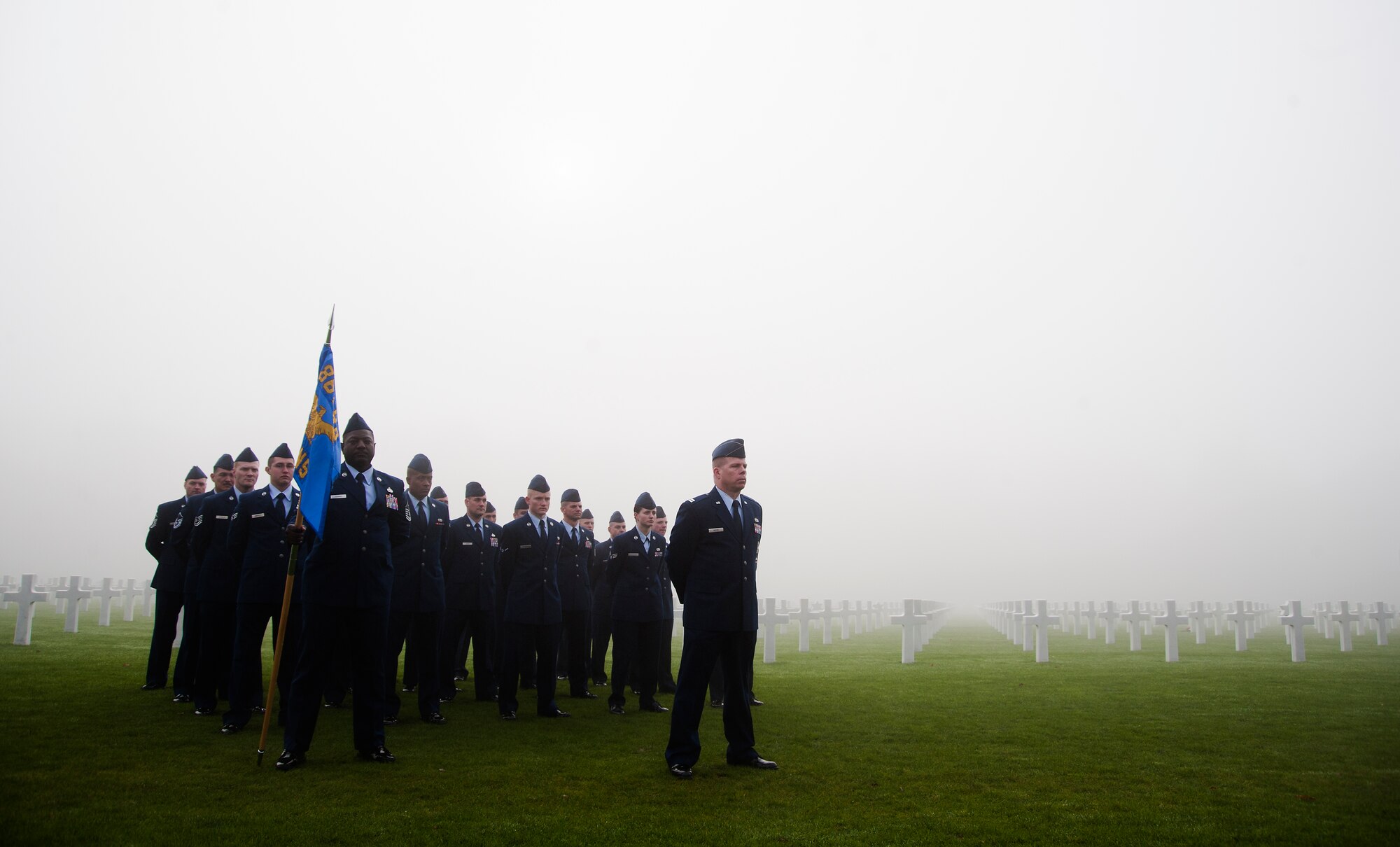 Members of the 86th Ammunition Squadron, stand at parade rest during a Veterans Day ceremony Nov. 11, 2013, Luxembourg American Cemetery and Memorial, Luxembourg.  The cemetery holds the remains of 5,076 American service members, most of which died during the Battle of the Bulge. (U.S. Air Force photo/Senior Airman Damon Kasberg)
