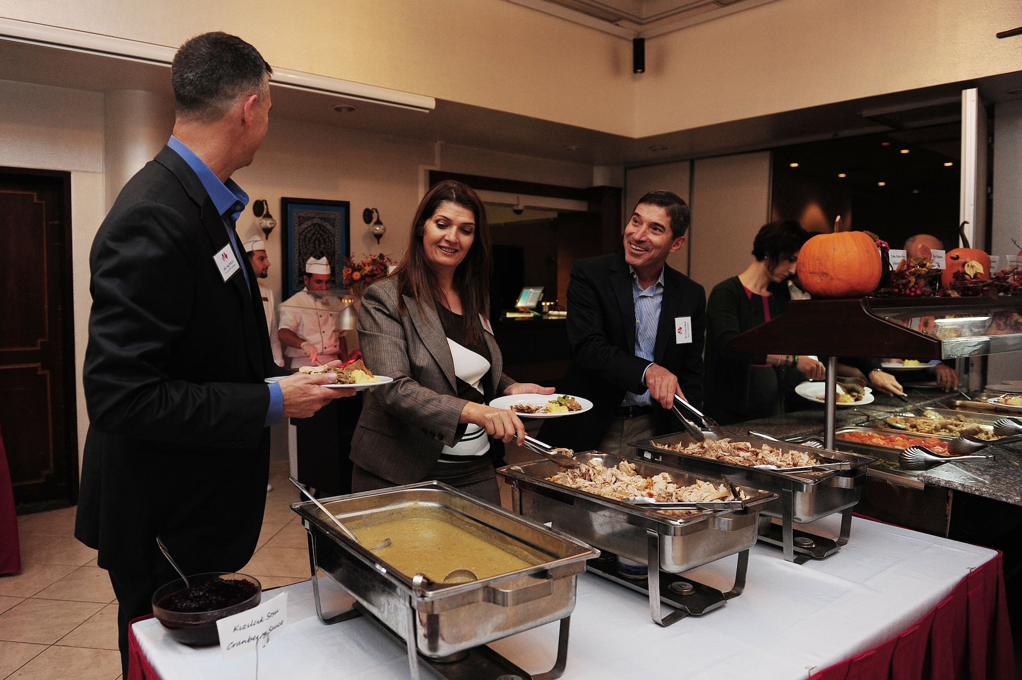 U.S. Air Force Col. Craig Wills, 39th Air Base Wing commander, Turkish air force Brig Gen. Serdar Gülbas, 10th Tanker commander, and his wife Tülin choose food from a Thanksgiving buffet line Nov. 16, 2013, at Incirlik Air Base, Turkey.  The dinner was a celebration and a thank you to the host nation for their partnership on Incirlik AB. (U.S. Air Force photo by Airman 1st Class Nicole Sikorski/Released)