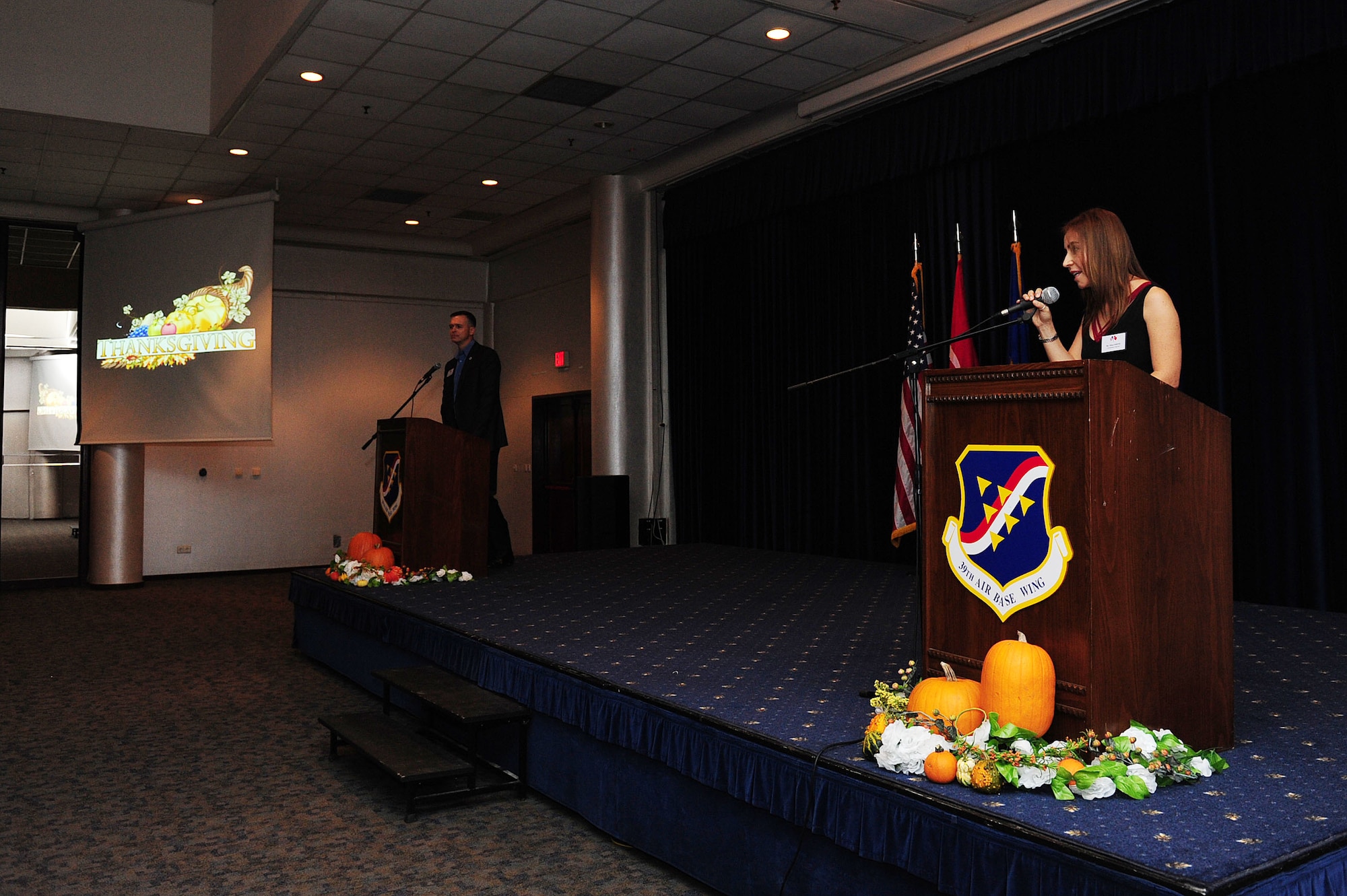 U.S. Air Force Col. Craig Wills, 39th Air Base Wing commander, and Mina Smith, 39th Air Base Wing international relations chief, speak at the Turkish American partnership dinner Nov. 18, 2013, at Incirlik Air Base, Turkey.  The dinner which included a social hour, a Thanksgiving meal and football celebrated the partnership between the 10th Tanker Command and 39th ABW.(U.S. Air Force photo by Airman 1st Class Nicole Sikorski/Released)