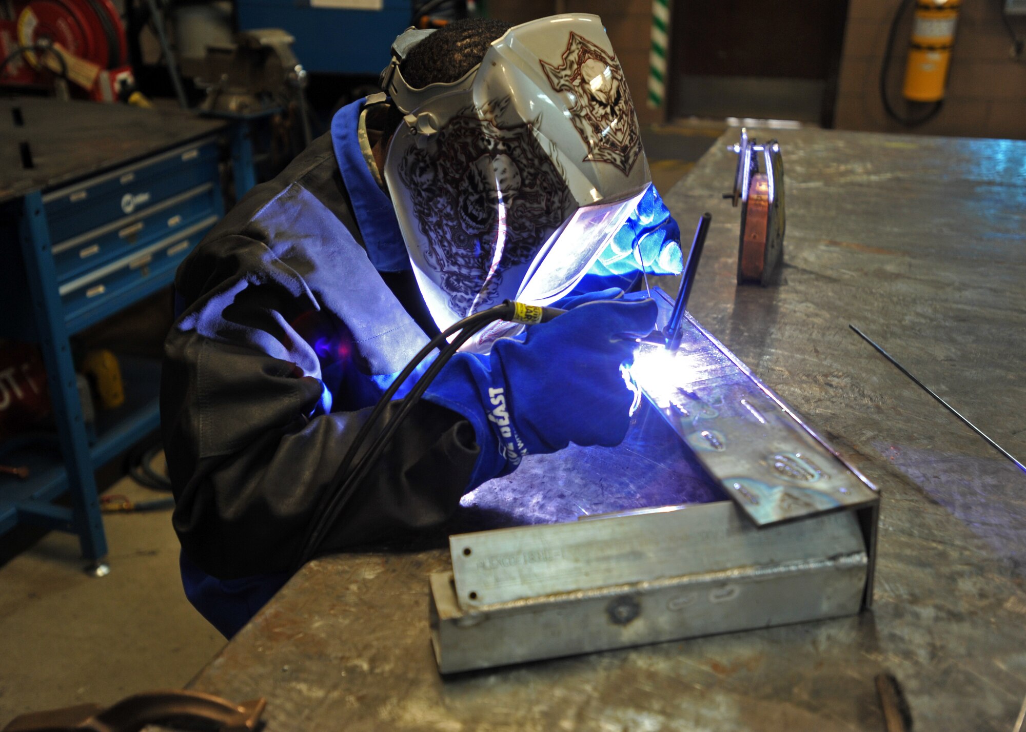 Senior Airman Mahrod Reese, 51st Maintenance Squadron aircraft metals technology journeyman, welds a piece of metal during Operational Readiness Exercise Beverly Bulldog 14-01 at Osan Air Base, Republic of Korea, Nov. 18, 2013. The metals technicians fix weapons, parts, ground equipment and aircraft. (U.S. Air Force photo/Senior Airman Siuta B. Ika)