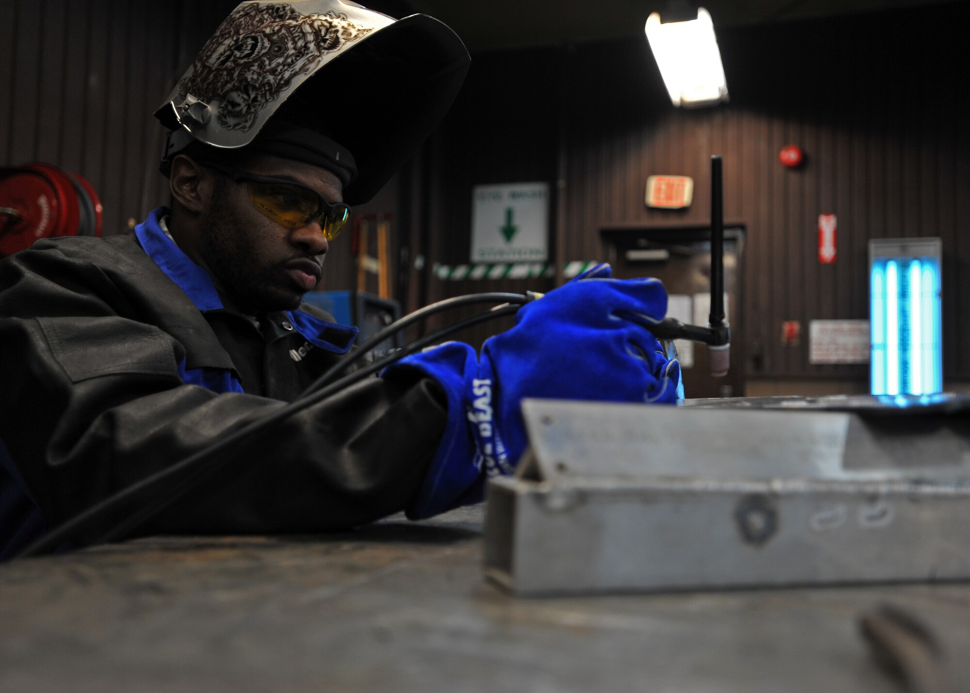 Senior Airman Mahrod Reese, 51st Maintenance Squadron aircraft metals technology journeyman, prepares to weld a piece of metal during Operational Readiness Exercise Beverly Bulldog 14-01 at Osan Air Base, Republic of Korea, Nov. 18, 2013. Working on everything from aircraft to underground equipment, the metals technology shop accomplishes a variety of metal work for units across the base. (U.S. Air Force photo/Senior Airman Siuta B. Ika)