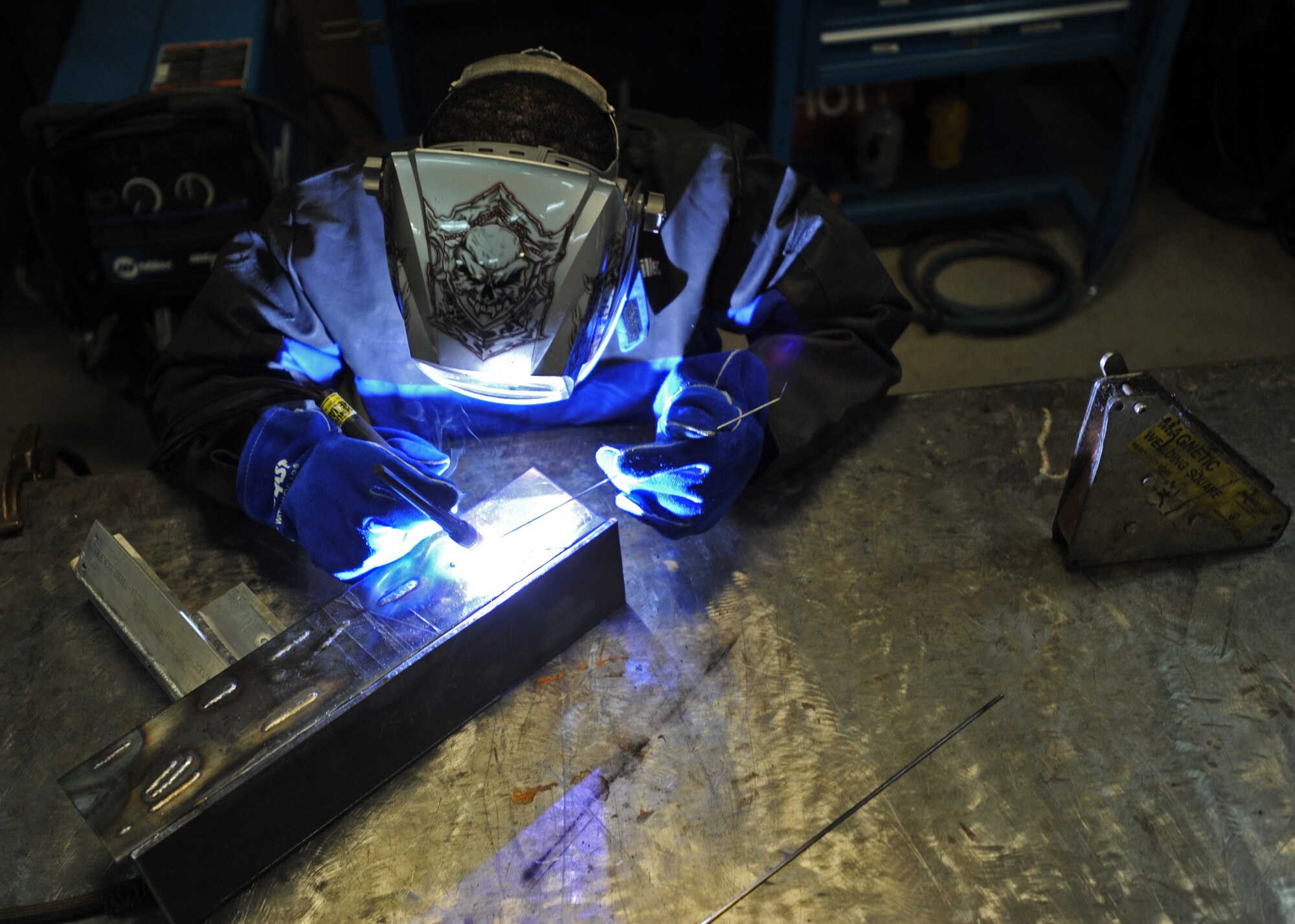 Senior Airman Mahrod Reese, 51st Maintenance Squadron aircraft metals technology journeyman, welds a piece of metal during Operational Readiness Exercise Beverly Bulldog 14-01 at Osan Air Base, Republic of Korea, Nov. 18, 2013. The metals technicians fix weapons, parts, ground equipment and aircraft. (U.S. Air Force photo/Senior Airman Siuta B. Ika)