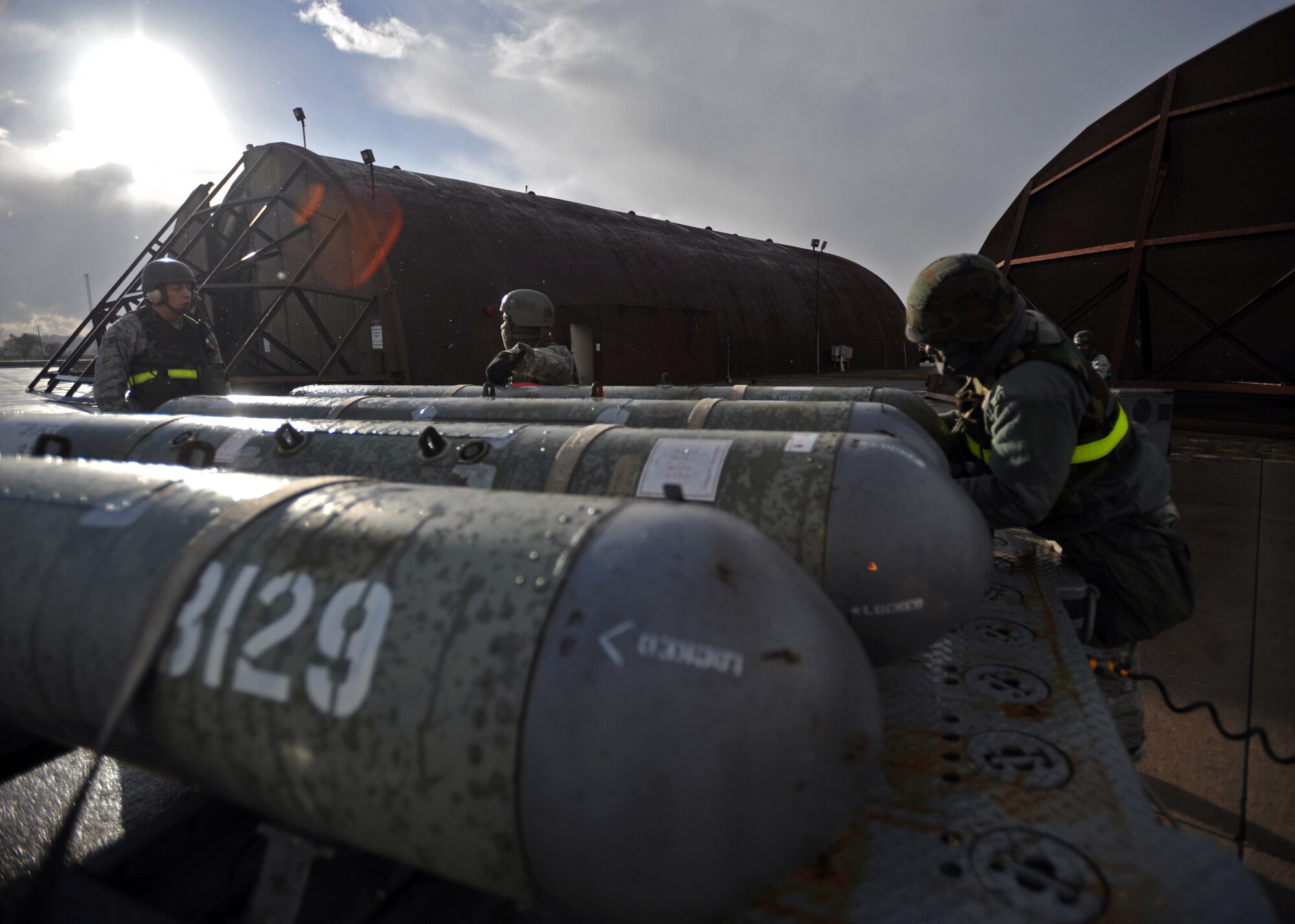 Weapons loaders from the 51st Aircraft Maintenance Squadron prepare to unload a munition during Operational Readiness Exercise Beverly Bulldog 14-01 at Osan Air Base, Republic of Korea, Nov. 18, 2013. Throughout the week, Osan Airmen will be tested on their ability to utilize their chemical, biological, radiological and nuclear training, as well as administer self aid and buddy care during contingency operations. (U.S. Air Force photo/Senior Airman Siuta B. Ika)