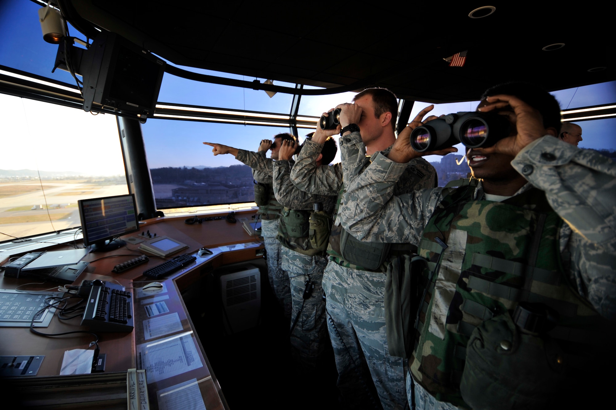 Air traffic controllers from the 51st Operations Support Squadron observe aircraft on the flight line during Operational Readiness Exercise Beverly Bulldog 14-01 at Osan Air Base, Republic of Korea, Nov. 18, 2013. Osan Airmen are in the first simulated wartime contingency exercise executed in the new fiscal year that will test the base's ability to defend and execute the mission in a heightened state of readiness. (U.S. Air Force photo/Staff Sgt. Emerson Nuñez)