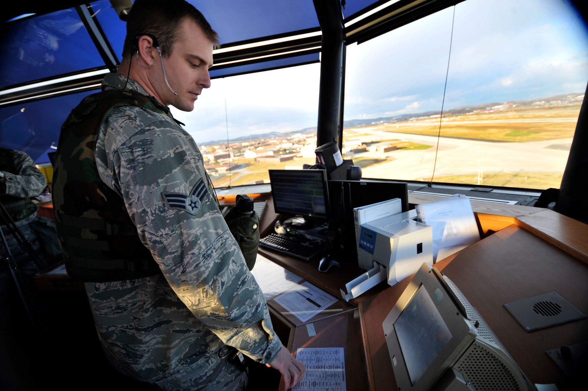 Senior Airman Jeffery Principe, 51st Operations Support Squadron air traffic controller, directs aircraft on the runway during Operational Readiness Exercise Beverly Bulldog 14-01 at Osan Air Base, Republic of Korea, Nov. 18, 2013. The exercise highlights Osan Airmen’s ability to position, employ and sustain forces, and showcase operational readiness. (U.S. Air Force photo/Staff Sgt. Emerson Nuñez)