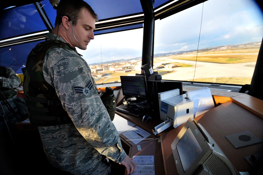 Senior Airman Jeffery Principe, 51st Operations Support Squadron air traffic controller, directs aircraft on the runway during Operational Readiness Exercise Beverly Bulldog 14-01 at Osan Air Base, Republic of Korea, Nov. 18, 2013. The exercise highlights Osan Airmen’s ability to position, employ and sustain forces, and showcase operational readiness. (U.S. Air Force photo/Staff Sgt. Emerson Nuñez)