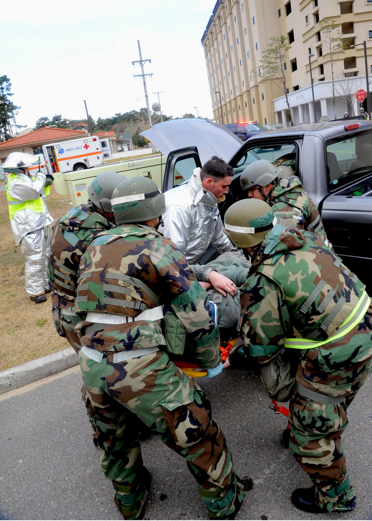 Airmen from the 8th Medical Group and the 8th Civil Engineer Squadron fire department work in unison to recover a simulated crash victim during Exercise Beverly Bulldog 14-1 at Kunsan Air Base, Republic of Korea, Nov. 18, 2013. Exercise Beverly Bulldog 14-1 demonstrates and enhances the readiness of the 7th Air Force to defend and sustain the capabilities which strengthen the ROK-U.S. Alliance. (U.S. Air Force photo by Staff Sgt. Jessica Haas/Released)