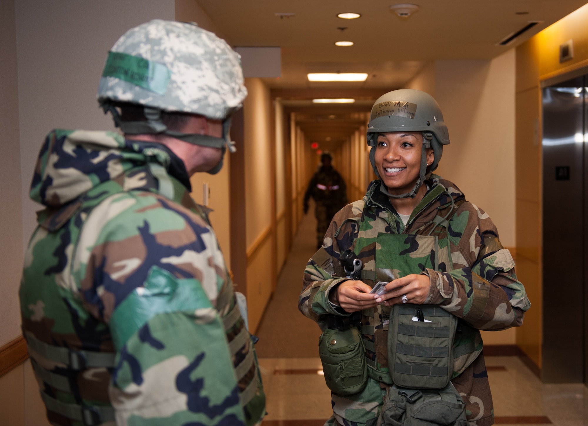 Master Sgt. LaTundra Williams, 8th Mission Support Group, speaks to Col. S. Clinton Hinote, 8th Fighter Wing commander, about the progress of the bed down procedure during Exercise Beverly Bulldog 14-1 at Kunsan Air Base, Republic of Korea, Nov. 18, 2013. The 8th Fighter Wing demonstrates its ability to room multiple Airmen in its chemical protection system dormitories. Airmen were moved from their non-protected dorms into shared rooms in CPS dormitories. The exercise tested the wartime mission alongside other 7th Air Force units and supporting organizations with an emphasis on the operational and tactical levels of war during the peninsula-wide exercise. (U.S. Air Force photo by Senior Airman Armando A. Schwier-Morales/Released)