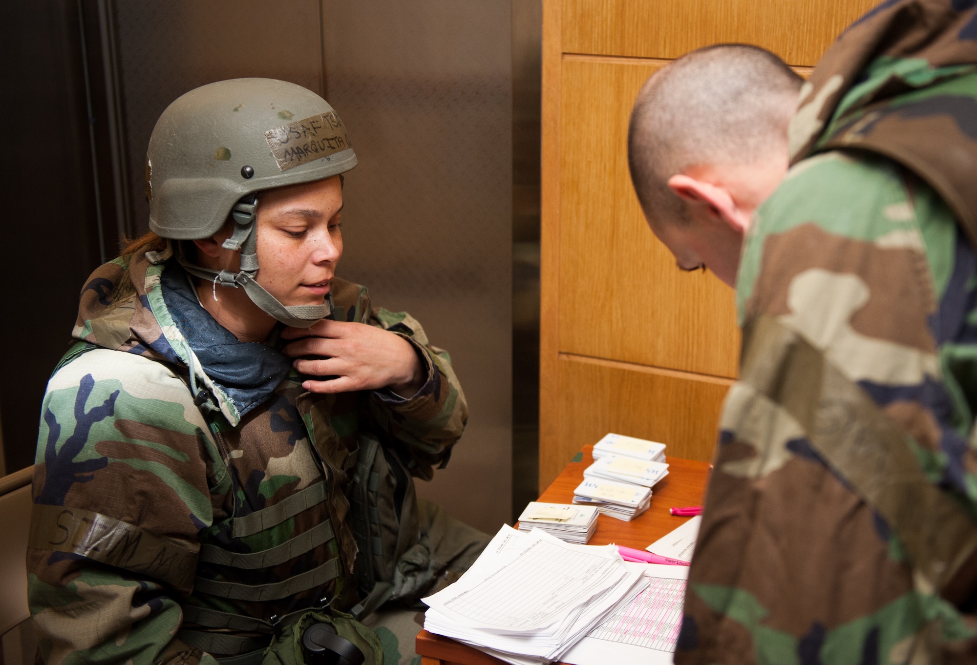 Tech. Sgt. Marquita Oliver, 8th Force Support Squadron, in-processes a new Airman into one of the base’s chemically protected dormitories during exercise Beverly Bulldog 14-1 at Kunsan Air Base, Republic of Korea, Nov. 18, 2013. The 8th Fighter Wing demonstrates its ability to room multiple Airmen in its chemical protection system dormitories. Airmen were moved from their non-protected dorms into shared rooms in CPS dormitories. The exercise tested the wartime mission alongside other 7th Air Force units and supporting organizations with an emphasis on the operational and tactical levels of war during the peninsula-wide exercise. (U.S. Air Force photo by Senior Airman Armando A. Schwier-Morales/Released)